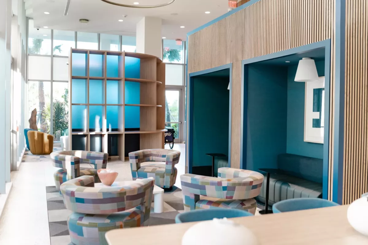 Private seating pods with upholstered benches and wood slat accents